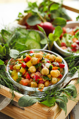 Healthy salad with chickpeas and chopped fresh vegetables, tasty and nutritious vegan food