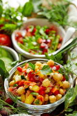 Fresh vegetarian salad with chickpeas, chopped peppers, onions, cucumbers, carrots and herbs. Healthy and nutrition diet