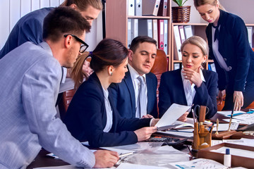Business people office life of team people working with papers sitting table . Cabinets with folders . Business people get together in office about economic project.