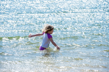 Young girl walking in water