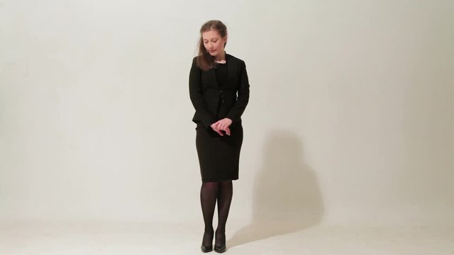 4in 1. Young beautiful girl in a black dress and shoes fooling around and saying goodbye on white background