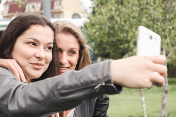 Two friends talk on the phone in nature