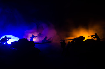 Naklejka na ściany i meble War Concept. Military silhouettes fighting scene on war fog sky background, World War Soldiers Silhouettes Below Cloudy Skyline At night. Attack scene. Armored vehicles.