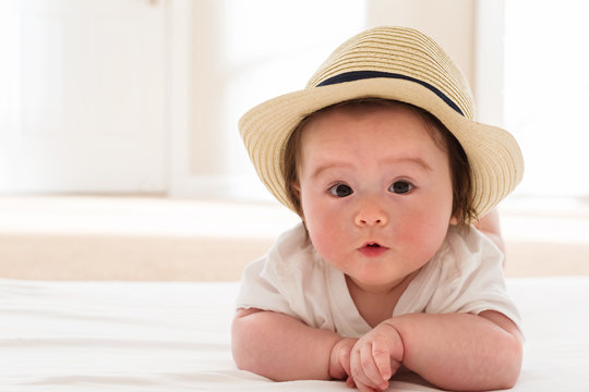 Happy Baby Boy With Straw Hat