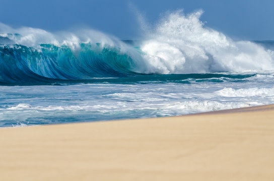 Ocean waves breaking on a sandy beach on the north shore of Oahu Hawaii