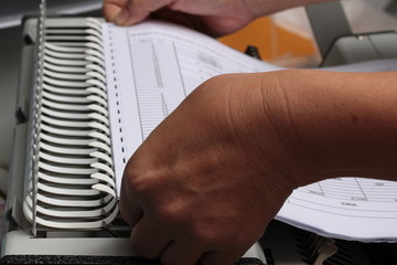 Binding documents with plastic ring binder.