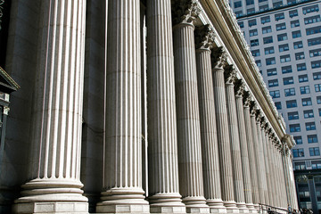 Old style building with a row of columns in an urban setting.