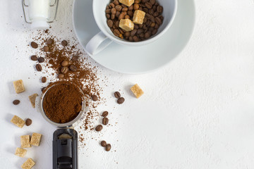 Ingredients for coffee: ground coffee in the horn of the coffee machine, sugar and a cup