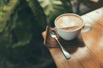 Hot coffee, Capucino coffee on the wooden table in selective focus.
