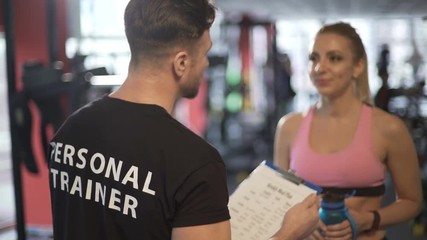 Personal trainer developing training program and explaining it to his client