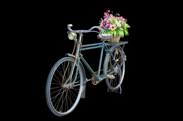 Fototapeta na wymiar Ancient bicycle Flower basket On a black background