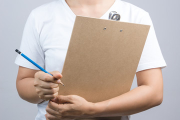 Woman hand holding wooden clipboard and a pen