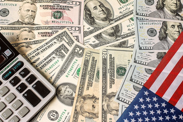 Calculator, dollars and USA flag