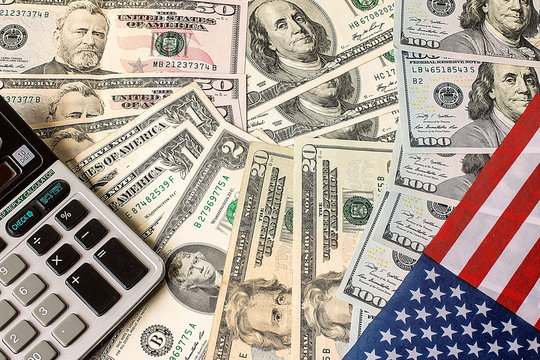 Calculator, dollars and USA flag - Powered by Adobe