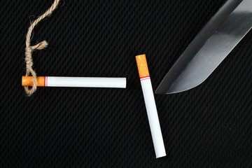 Cigarette and knife represent stop smoke cigarette concept idea.