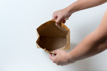 in the hands of an empty paper bag