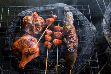  top view. chicken ass,checken hip and catfish grilled on steel stove but seems delicious. this image for food concept