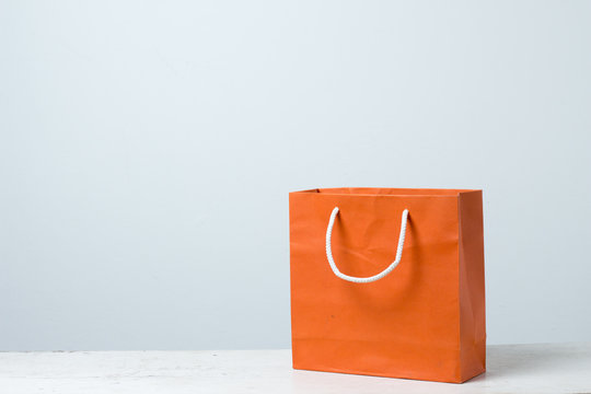 Orange Shopping Bag On Wooden Table