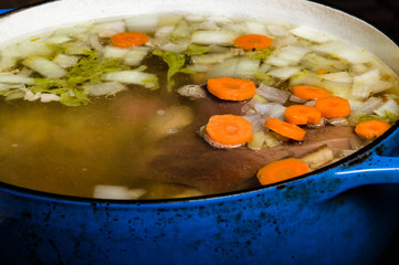 Vegetable ham soup cooking on the stove
