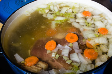Vegetable ham soup cooking on the stove