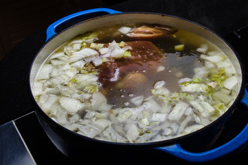 Vegetable ham soup cooking on the stove