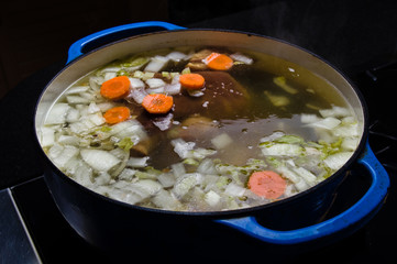 Vegetable ham soup cooking on the stove