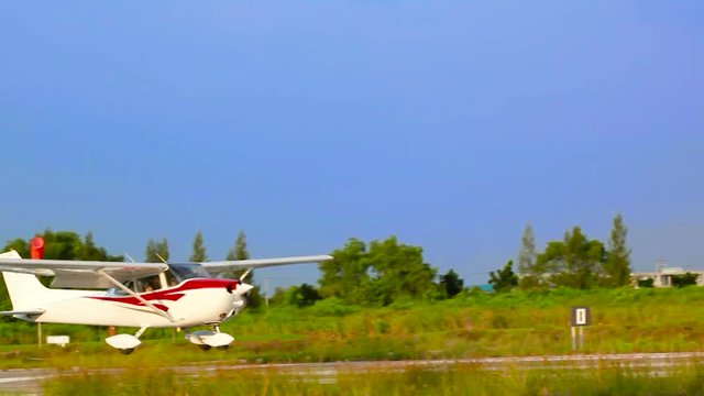 Small airplane with propeller in front are landing on runway.