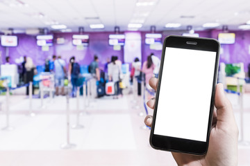 A man hand holding smart phone with background people check in for get on the plane. Smartphone with blank screen and can be add your texts or others on smart phone.
