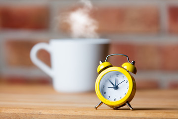 Fototapeta na wymiar cup of coffee and alarm clock