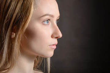 Fototapeta premium Portrait of a beautiful young woman with blue eyes.