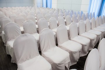 Empty white chair arrange in row for seminar or meeting room