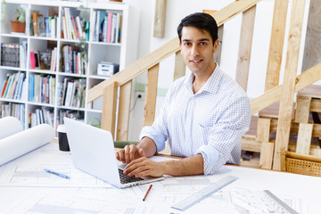 Young man architect in office