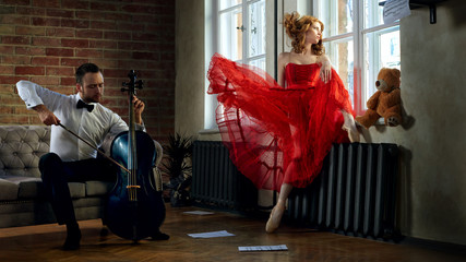 Caucasian handsome cellist visits the muse from fairytale in red dress © Alex Shadrin