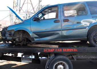 Recycling scrap car removal service for future dismantling and metal and parts reuse.