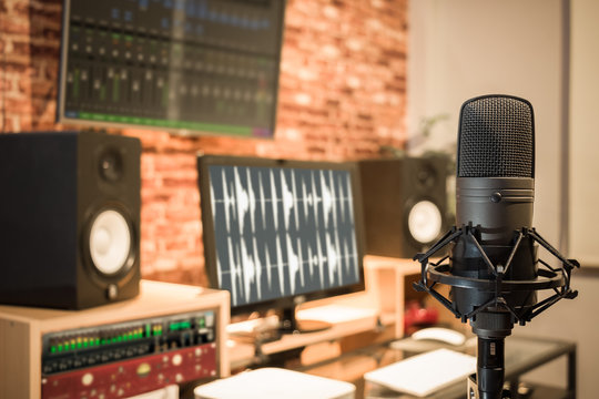 condenser microphone on digital recording studio background 