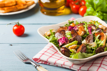 Warm salad with grilled chicken liver and toast