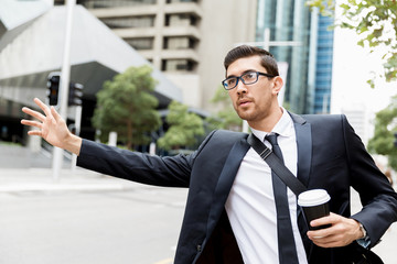 Young businessman hailing for a taxi