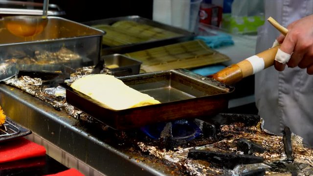 Japanese Chef Frying omelette on rectangular pan