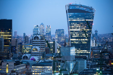 City of London business aria view at night. Walkie-Talkie building and Canary Wharf at the...