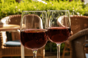 Two glasses of red wine on a terrace