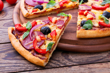 Delicious pizza served on wooden table. Italian pizza close up, top view, horizontal