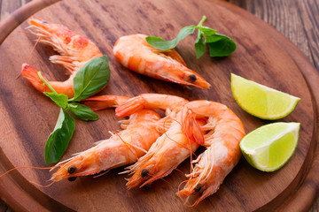 Delicious fresh seafood shrimp with lime on wooden table top view