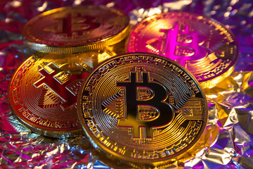 Cryptocurrency physical golden bitcoin coin on colorful background