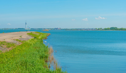 Dike of stones along a lake in spring