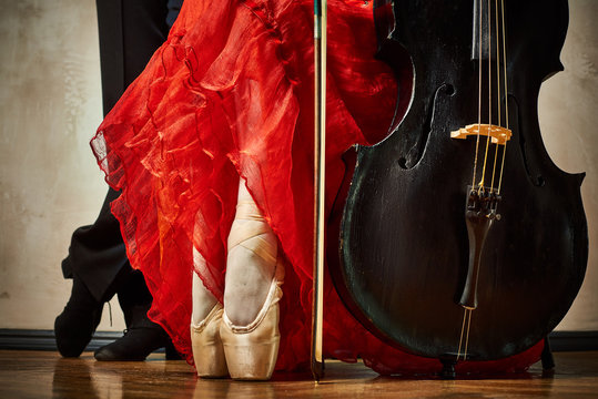 Close up photo of ballet pointe and latin dancers shoes and cello
