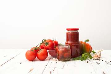 Recipes for tomatoes in jars on white