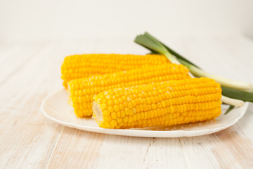 Two of the cob cooked corn on white background