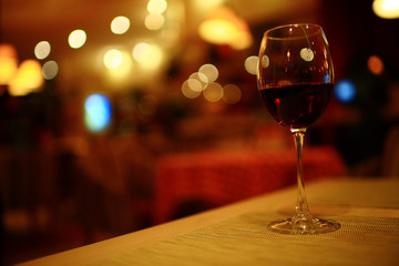 Serving a glass of red wine in a restaurant