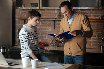 Attentive male person looking at notebook