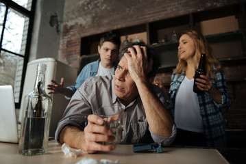 Portrait of upset man while keeping empty glass in right hand